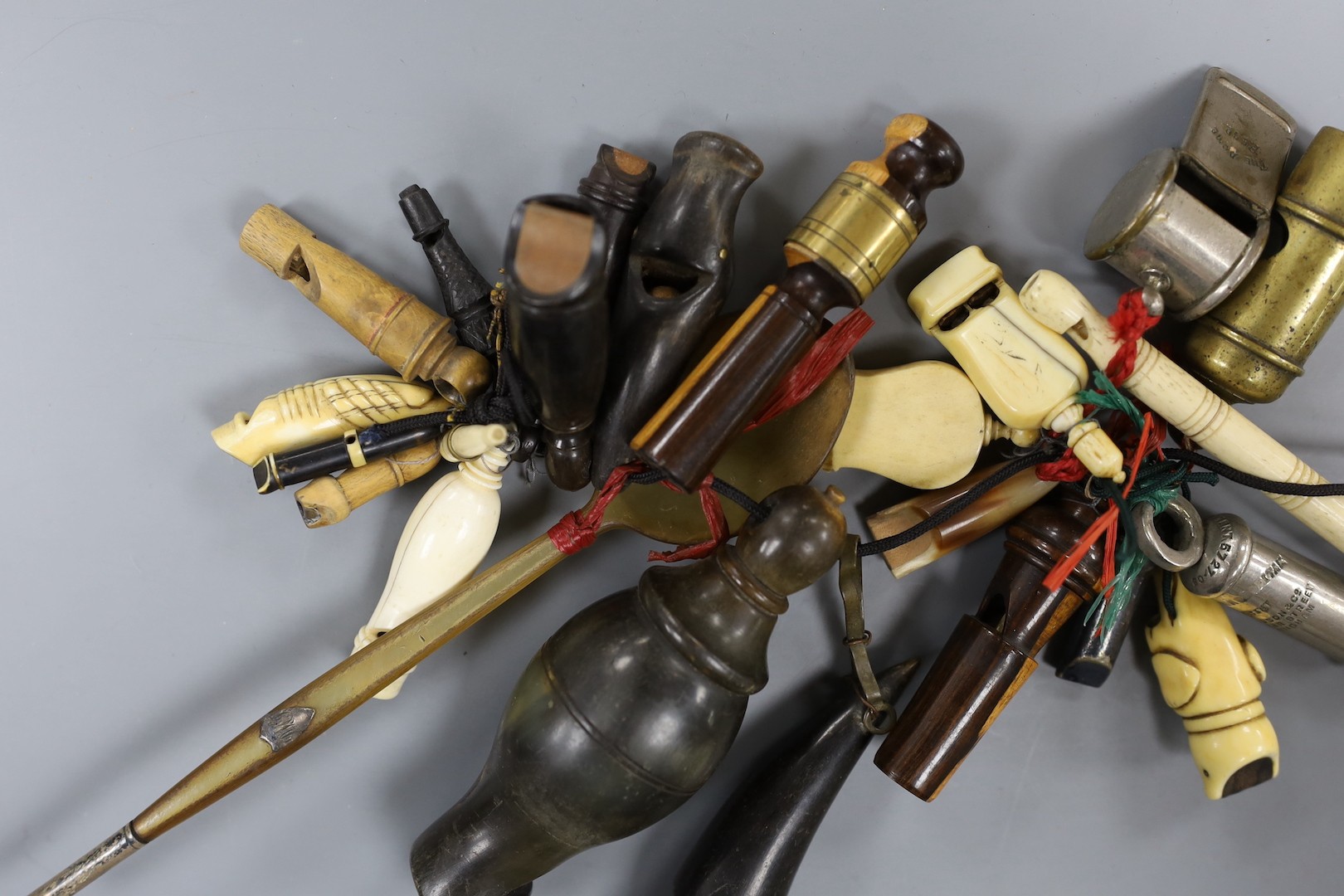 A collection of various collectable 19th century whistles, including bone, pewter, horn, ebony, brass and some ivory.